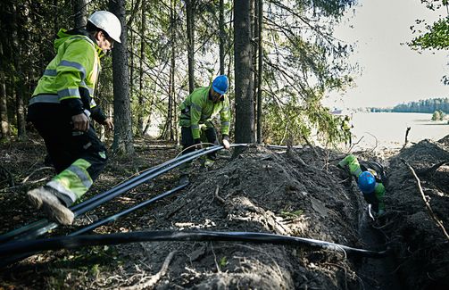 Cable workers installing Axal-TT medium voltage cable in rough terrain